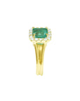 14K yellow gold ring with a square Colombian emerald haloed by diamonds on a split shank.