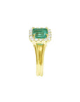 14K yellow gold ring with a square Colombian emerald haloed by diamonds on a split shank.