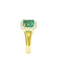 14K yellow gold ring with a square Colombian emerald haloed by diamonds on a split shank.