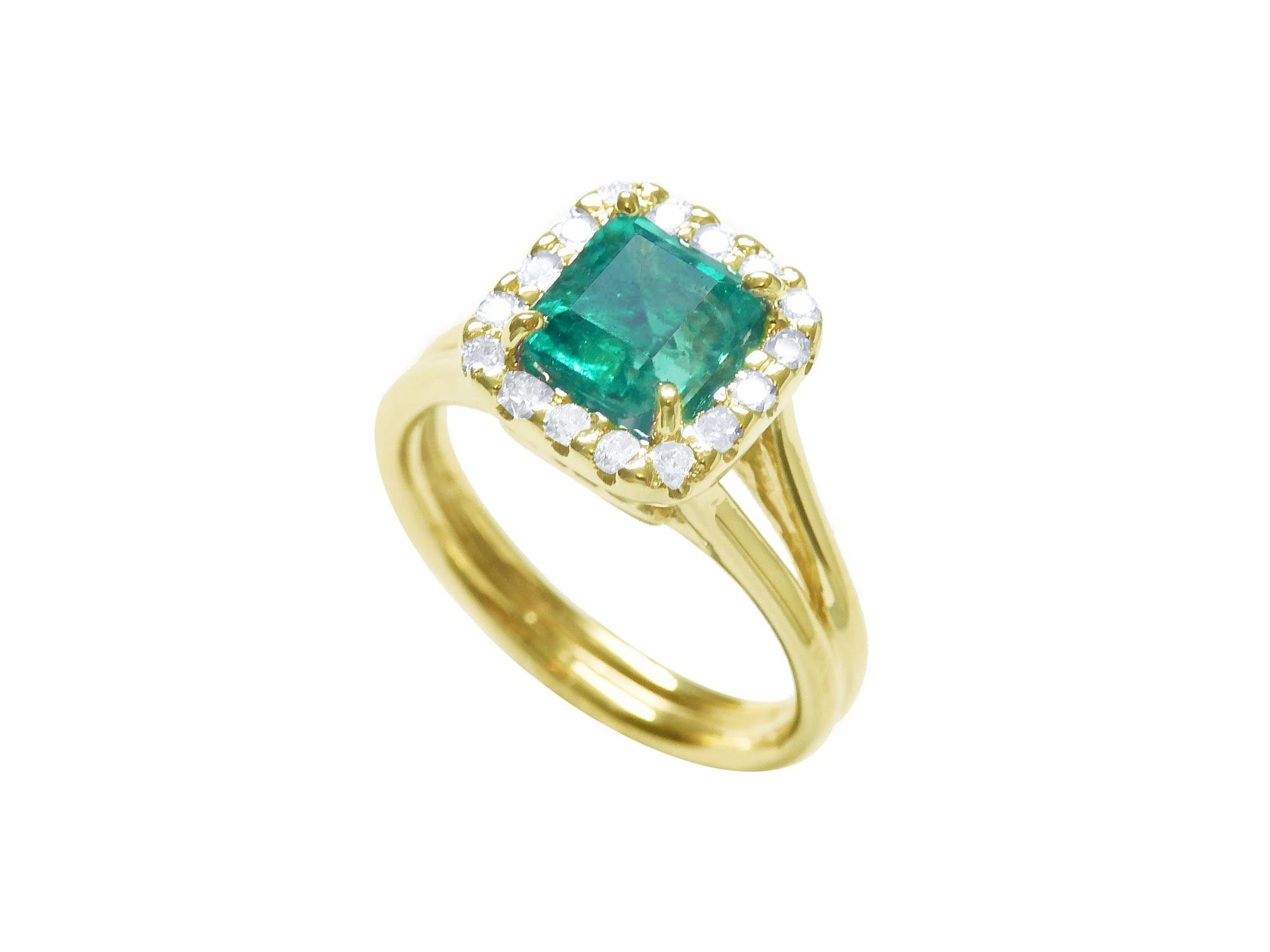 The tilted position of this square emerald ring displays the halo diamond and side shank profile.