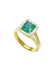 The tilted position of this square emerald ring displays the halo diamond and side shank profile.