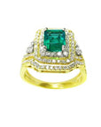 This Colombian emerald and match band ring has a double halo of natural diamonds, top and side profile visibles.