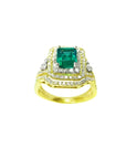 1.31 ct emerald-cut emerald ring with double halo diamonds and matching band in 14K yellow gold.