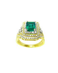 1.31 ct emerald-cut emerald ring with double halo diamonds and matching band in 14K yellow gold.