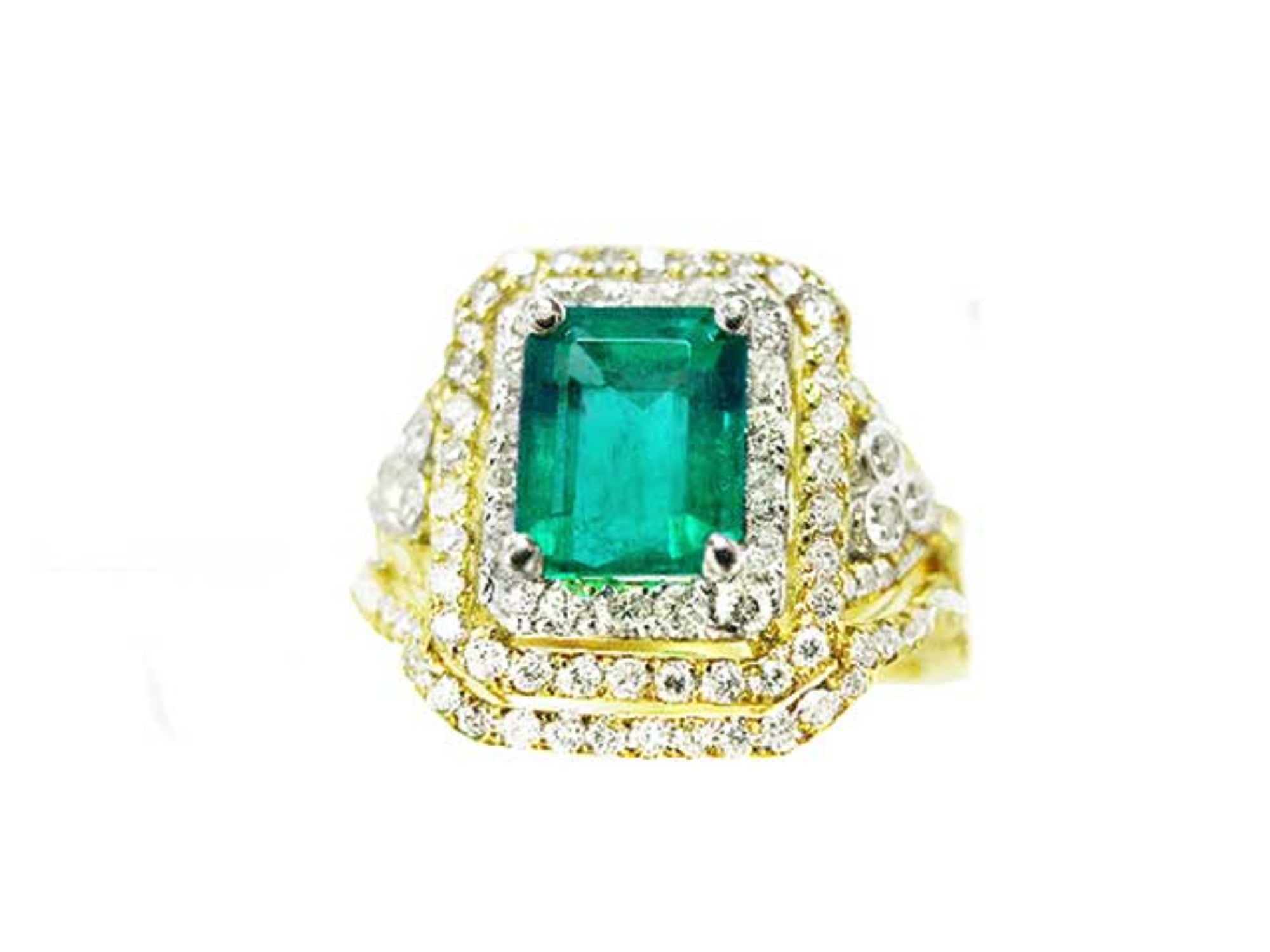 This Colombian emerald ring with matching band has a double halo of diamonds and it was crafted in 14k yellow gold, topside view.