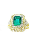 This Colombian emerald ring with matching band has a double halo of diamonds and it was crafted in 14k yellow gold, topside view.