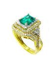 The top and parcial lateral profile of a yellow gold colombian emerald ring with matching band are displayed.