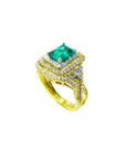 The top and parcial lateral profile of a yellow gold colombian emerald ring with matching band are displayed.