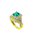 1.31 ct. emerald-cut emerald ring with double diamond halo and matching band in 14K yellow gold.