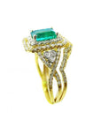 Side profile of a yellow gold emerald and matching band ring with accent diamonds, top gemstone and side bands profile visibles.