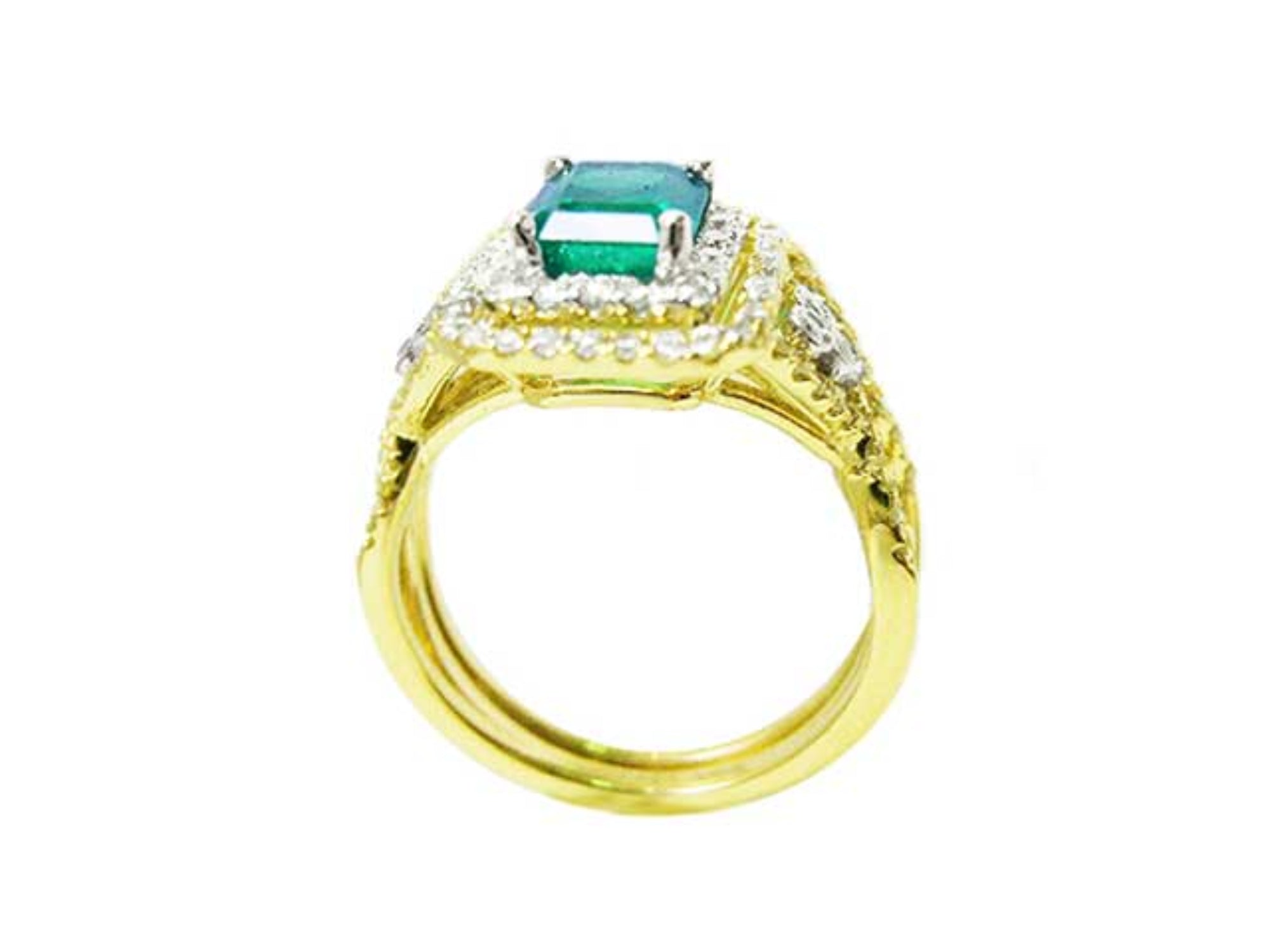 A 14k yellow gold emerald ring and diamond accents on a white background.