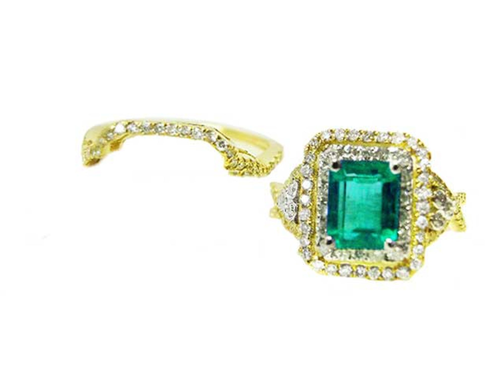 Topside of an emerald-cut emerald ring with double halo diamond and aside the matching band.
