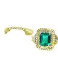 1.31 ct emerald-cut emerald ring with double diamond halo and matching diamond band in 14K yellow gold.
