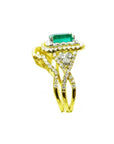 A side profile view of a natural emerald ring with the matching band and accent diamonds in yellow gold.
