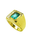 Gold men's ring with a genuine Muzo colombian emerald on a partial side angle.