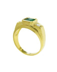 Men's 18K yellow gold ring with a bezel-set Colombian emerald and two side diamonds.