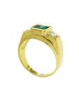 Men's 18K yellow gold ring with a bezel-set Colombian emerald and two side diamonds.