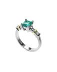 A square emerald with accent diamonds white gold ring.