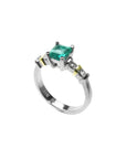 14K white gold ring with a square emerald cut Colombian emerald and side accent diamonds.
