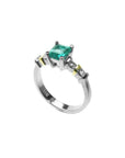 14K white gold ring with a square emerald cut Colombian emerald and side accent diamonds.