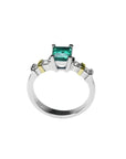 14K white gold ring with a square emerald cut Colombian emerald and side diamonds.