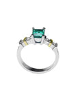 14K white gold ring with a square emerald cut Colombian emerald and side diamonds.