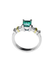 14K white gold ring with a square emerald cut Colombian emerald and side diamonds.
