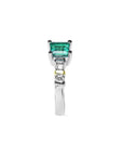 14K white gold ring with a square emerald cut Colombian emerald and side diamonds.