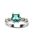 A square natural colombian emerald and accent diamonds ring made of 14k white gold.