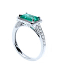A natural emerald and diamonds ring in white gold displaying the top and partial side view.
