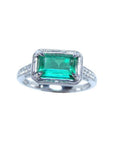 Natural emerald and diamond ring prong set and side diamonds of the band design.