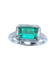 Natural emerald and diamond ring prong set and side diamonds of the band design.