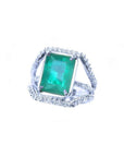 Emerald-cut 3.90 ct natural bluish-green emerald ring with triple diamond rows in 14K white gold.