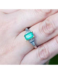 A platinum and 18k gold emerald ring for women with a natural colombian emerald and diamonds.