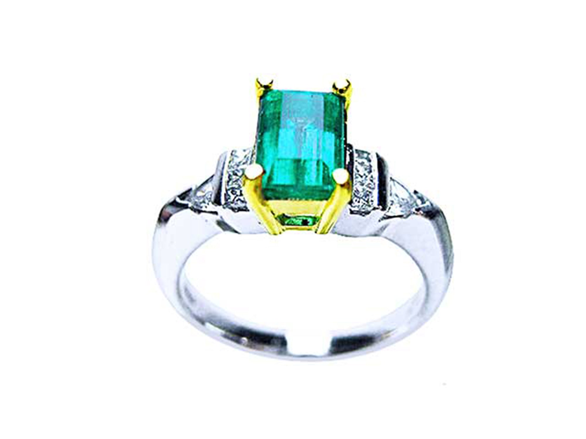 Platinum emerald ring with side diamond accents on a white background.