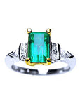 Platinum emerald ring and 18k yellow gold setting with accent side diamonds top view.