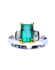 Platinum emerald ring and 18k yellow gold setting with accent side diamonds top view.