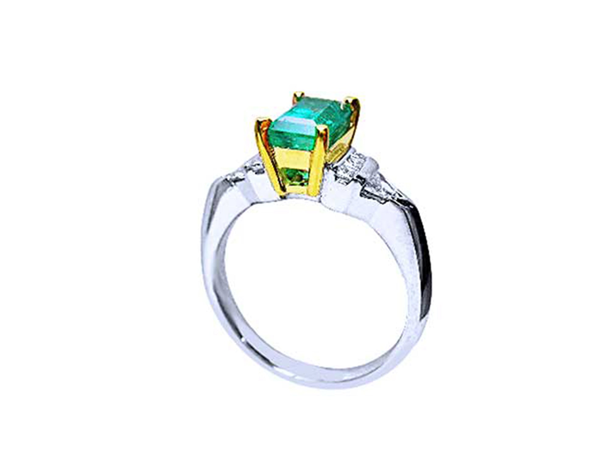 A platinum with a 18k yellow gold setting holding a natural colombian emerald.