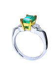 A platinum with a 18k yellow gold setting holding a natural colombian emerald.