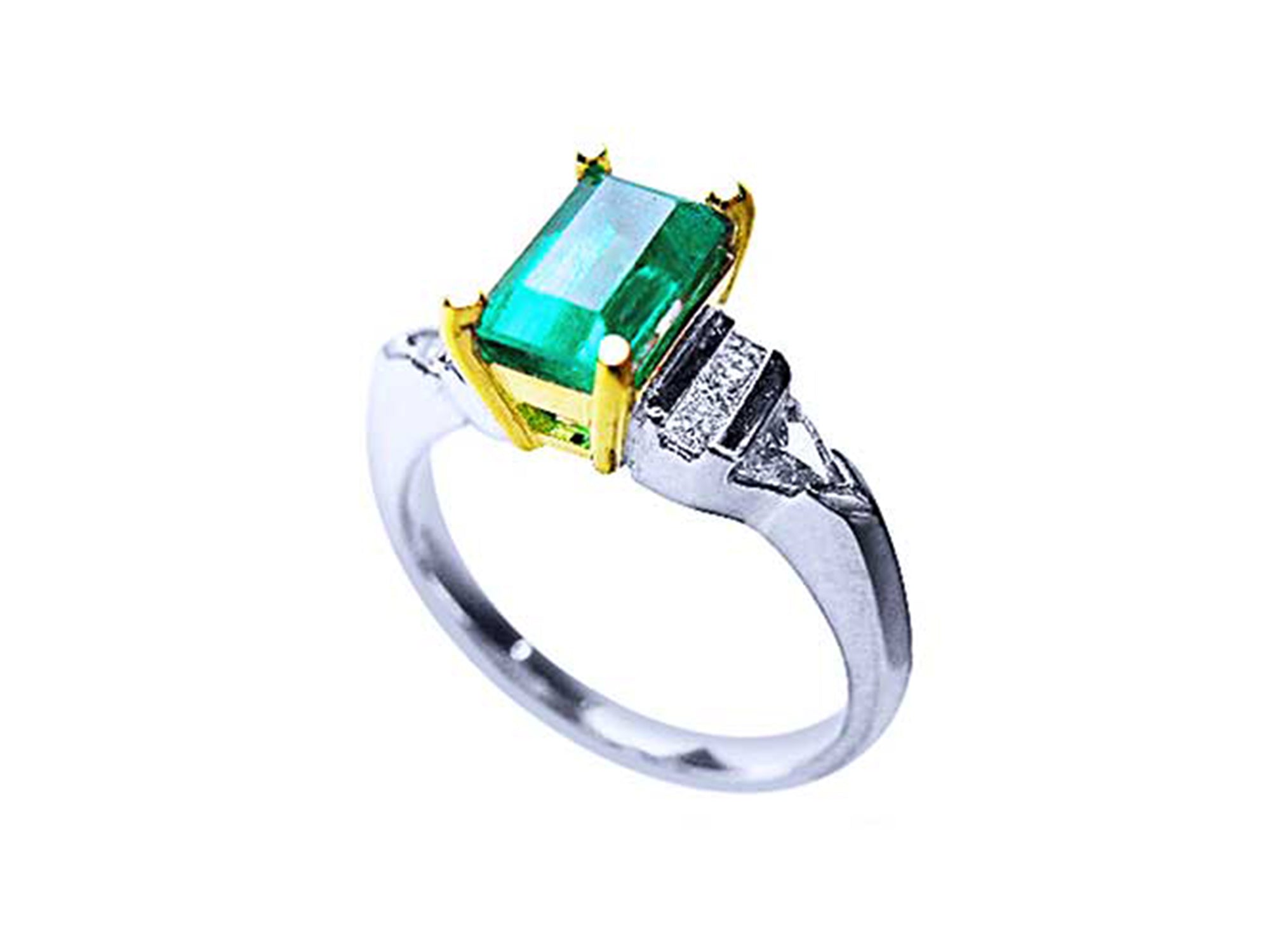 Platinum emerald ring and yellow gold setting on a white background,