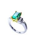 Platinum emerald ring and yellow gold setting on a white background,