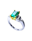 Platinum ring with 1.21 ct. emerald in 18K yellow gold setting, accented by natural diamonds.