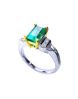 Platinum ring with 1.21 ct. emerald in 18K yellow gold setting, accented by natural diamonds.