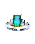 Platinum emerald ring and 18k yellow gold setting with accent side natural diamonds.