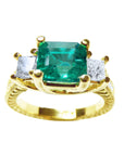 This emerald and princess cut side diamond ring is displaying the top and side profile view.