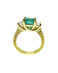 18K yellow gold ring with a rectangular emerald center stone and princess-cut side diamonds, antique decor.