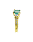 Emerald and princess cut diamond women's ring displaying it side profile from top to down.