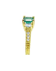 Emerald and princess cut side diamond ring in 18K yellow gold with antique decor.