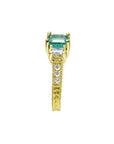 Emerald and princess cut side diamond ring in 18K yellow gold with antique decor.
