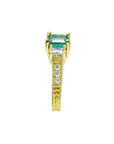 Emerald and princess cut side diamond ring in 18K yellow gold with antique decor.